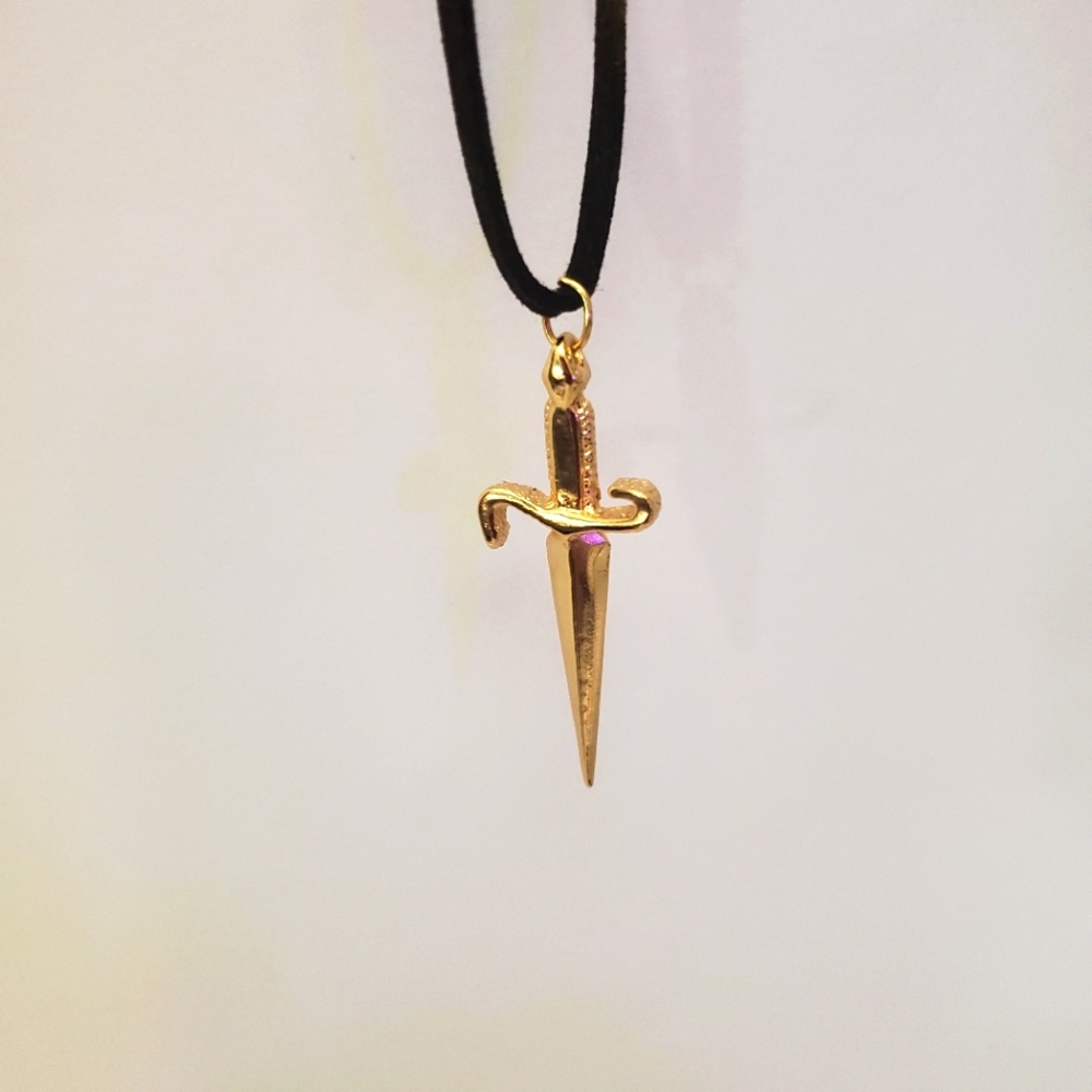 Gold dagger/knife pendant.